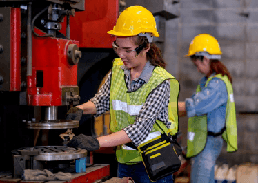 Workers in high viz operating heavy machinery
